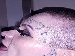 Lyrik Allure, with her tattoos, performs a blowjob at the gloryhole and receives a facial in this third part.