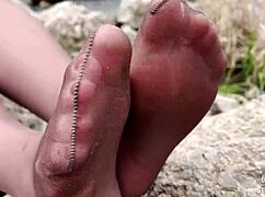 Goddess in spring forest teases with feet in tan pantyhose