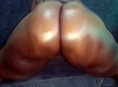 Oiled up ebony babe spreads her booty for daddy