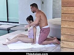 Big guy rams his thick cock into her young Asian throat.