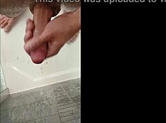 Muscular man washes his cock in the shower