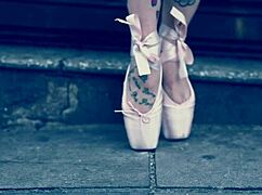 Ballerina strolls in ballet shoes on the street
