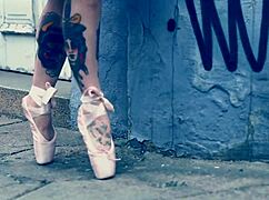 Ballerina strolls in ballet shoes on the street