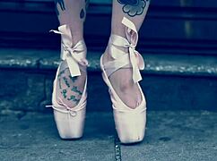 Ballerina strolls in ballet shoes on the street