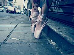 A blonde ballerina in ballet shoes walks down the street and gets her feet licked by a stranger