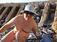 look at this hairy mature lady chilling on a nudist beach