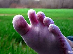 Goddess shows off cute feet in white socks on spring grass