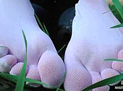 Goddess shows off cute feet in white socks on spring grass