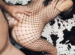 Wife rides in cowgirl position wearing mesh bodysuit.