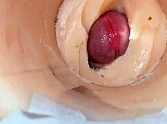 Camera deep inside tight pussy captures huge cum explosion, wet and shaved.