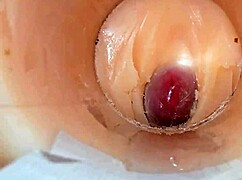 Camera deep inside tight pussy captures huge cum explosion, wet and shaved.