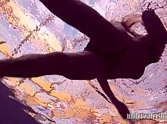 Lucy takes off her bikini in the pool, teasing underwater