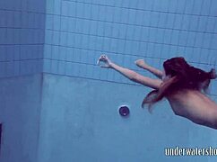 Lucy takes off her bikini in the pool, teasing underwater