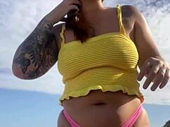 Can you see her swollen pussy lips flashing in that tiny bikini?