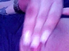 She touches herself while watching porn in her room.