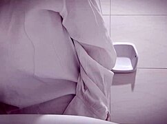 Sexy horny office girl masturbating, showing big tits and tight pussy in bathroom.