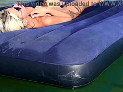 Beautiful blonde girl enjoys nude beach with big boobs and dolphin tattoo in public nudist outdoor setting