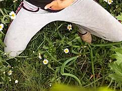 Neighbor masturbating to orgasm in outdoor daisies