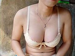 An amateur shemale masturbates nervously in the open bathroom.