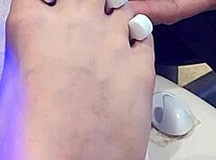 Shemale receives foot treatment.