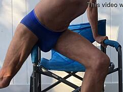 deep pelvic stretching in blue briefs on a blue chair during late october 2024