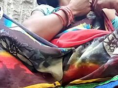 In a desi village, a woman carefully removes her saree using her finger