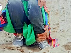 In a desi village, a woman carefully removes her saree using her finger