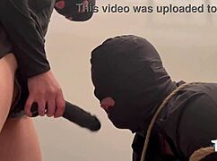 femdom mistress binds slave then fists his ass with huge black strapon dildo relentlessly